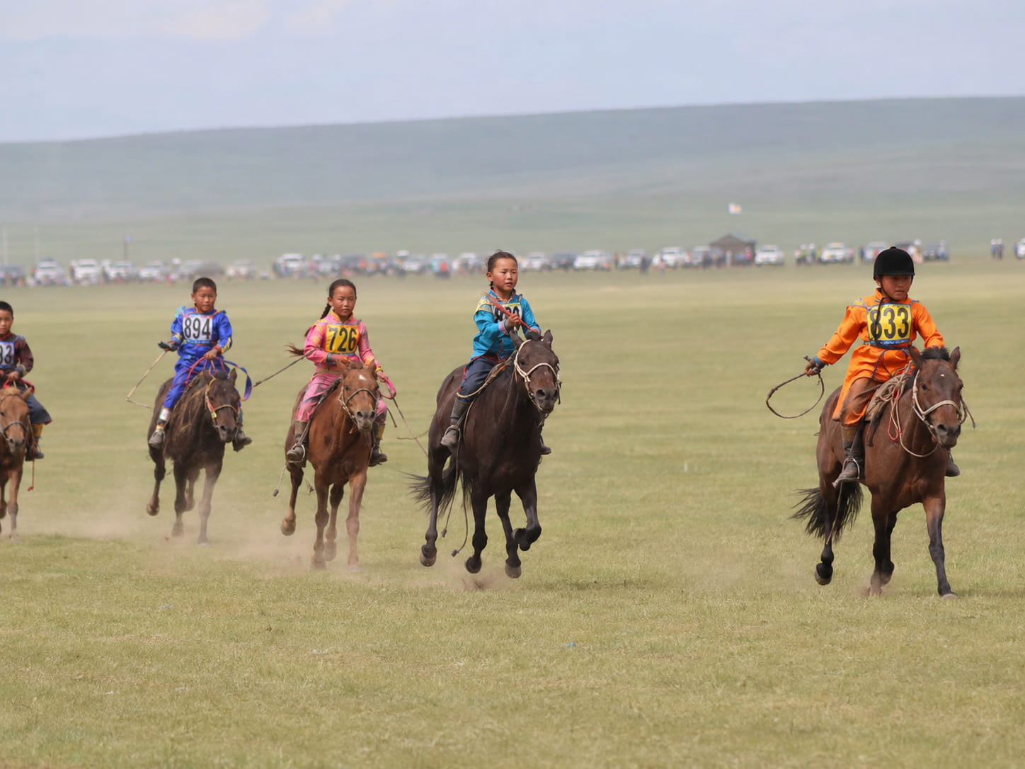 Young riders taking part in a Naadam horse race in the Mongolian steppe