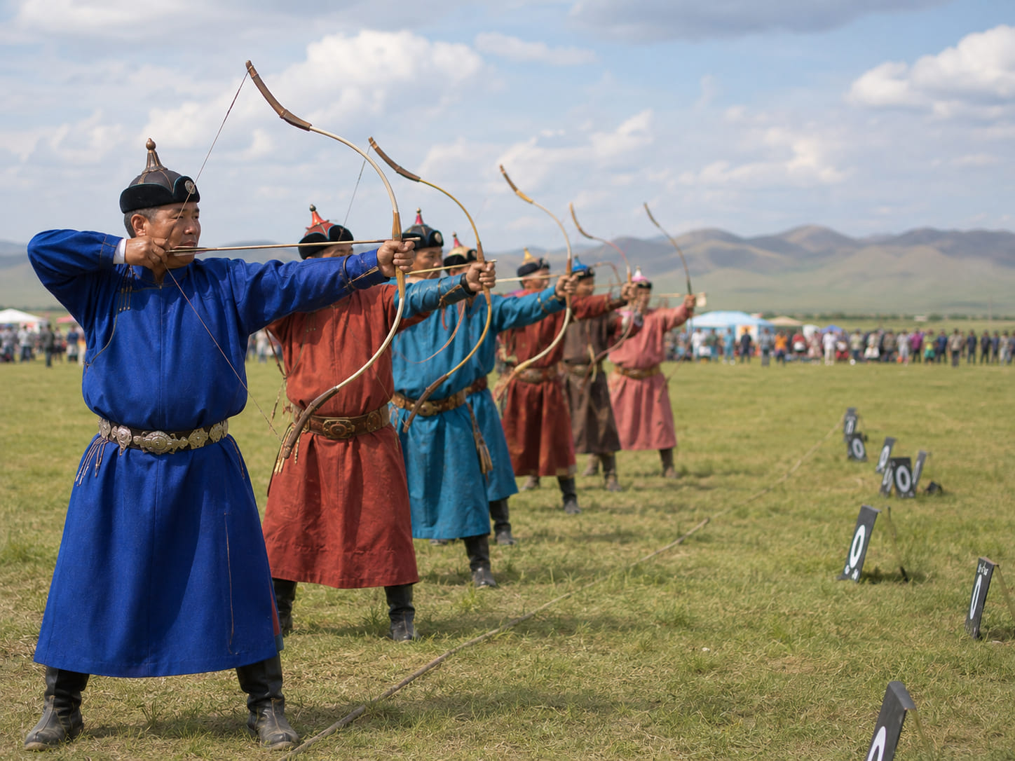 Mongolian archers wearing traditional deel during a Naadam archery event